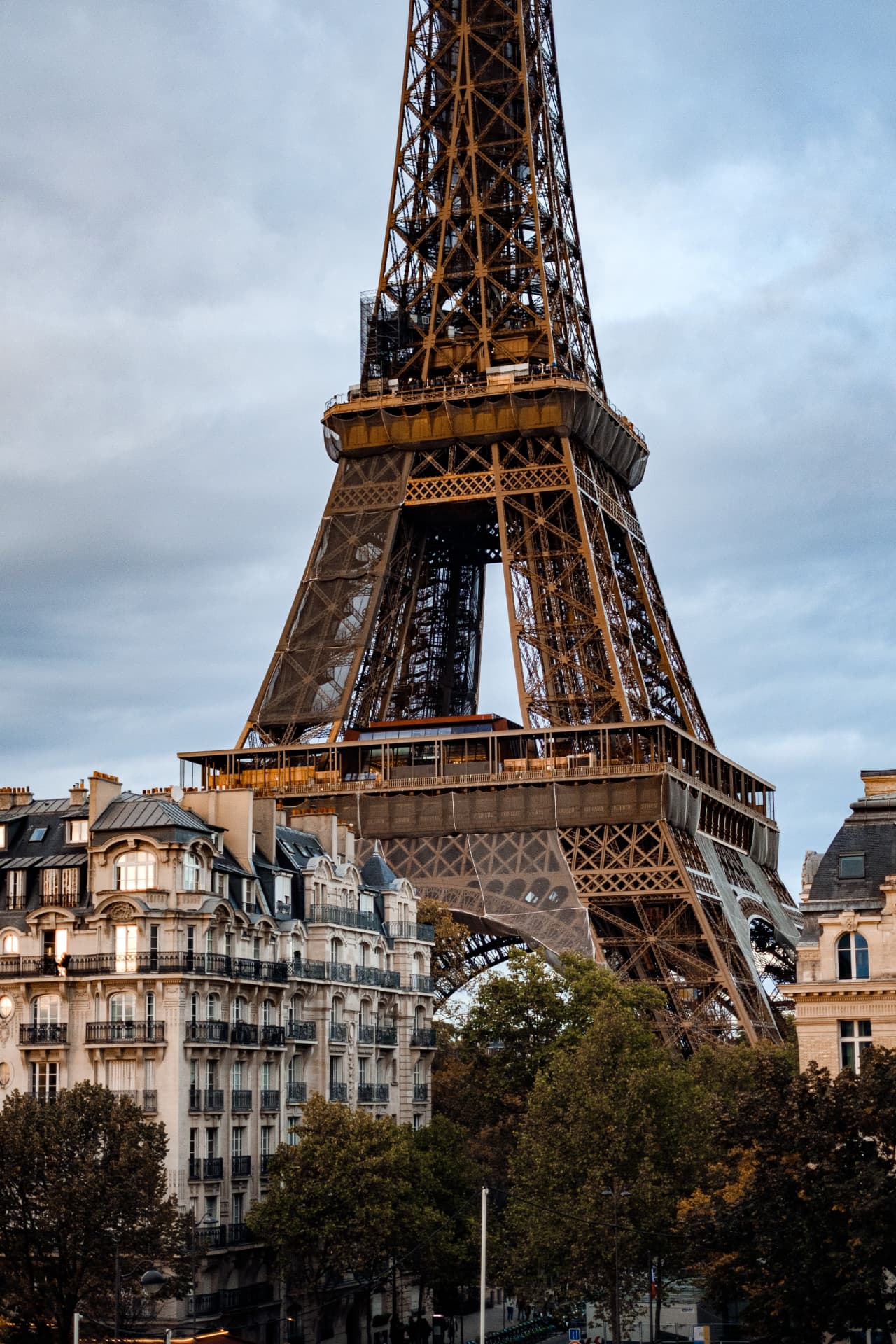 The Eiffel Tower above Haussmann rooftops at dusk